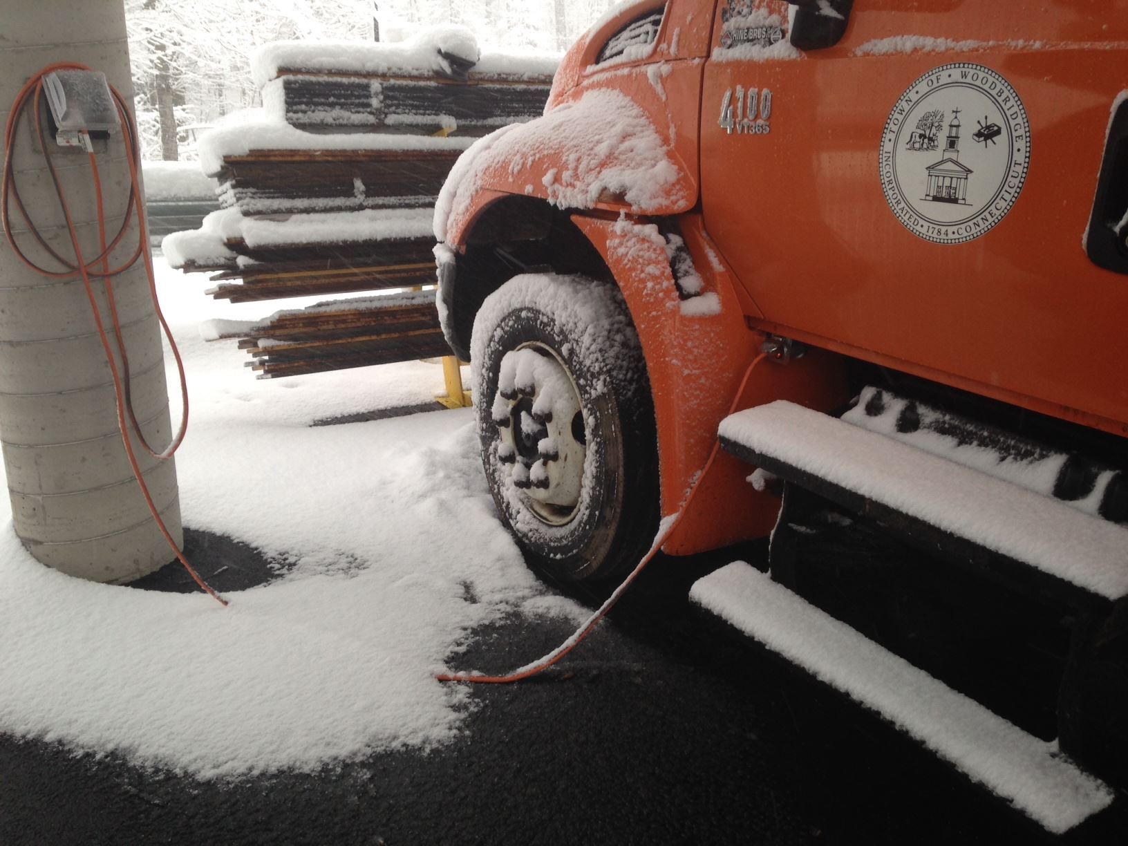 snowy plugged in plow truck